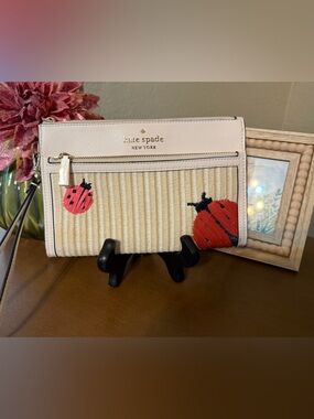 kate spade cream straw wristlet with red ladybug accents